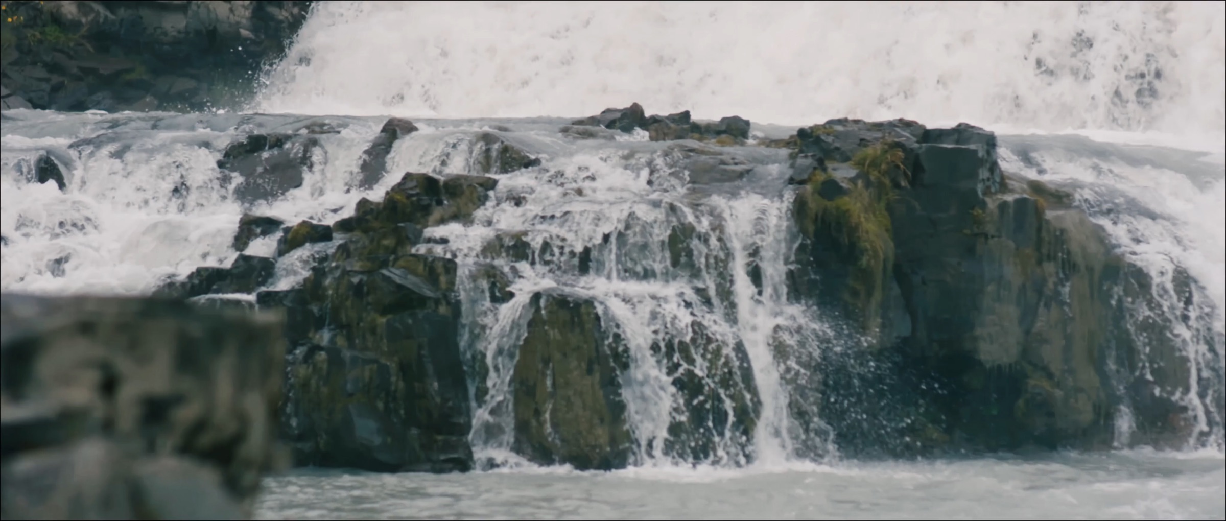 Water rushing over mossy rocks