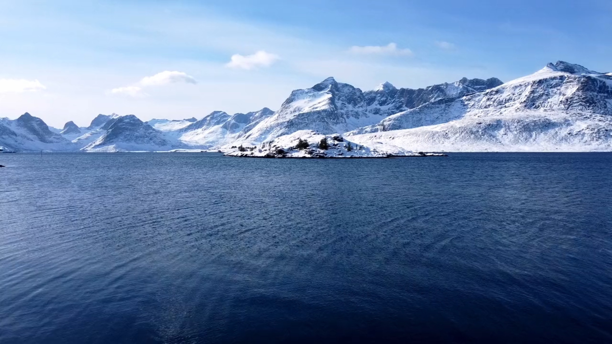 Snow-capped mountains above still water