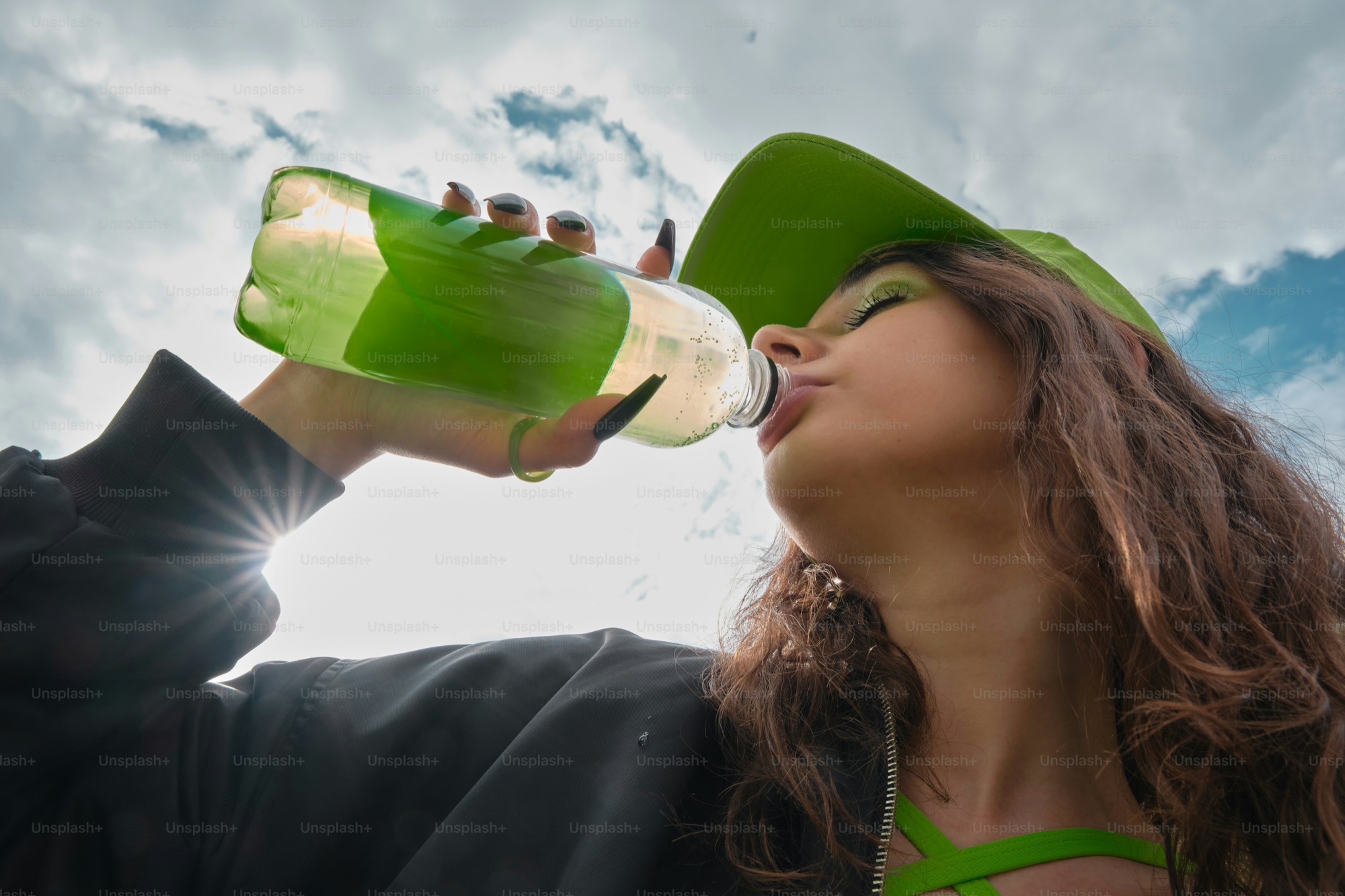 A woman drinking spring water outdoors